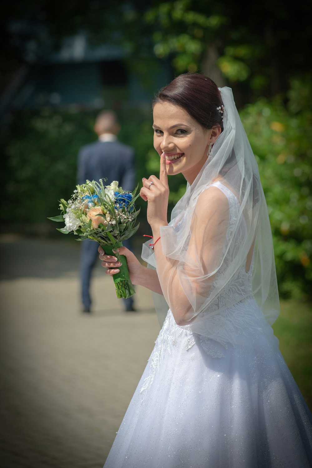 woman in white wedding dress holding bouquet of flowers