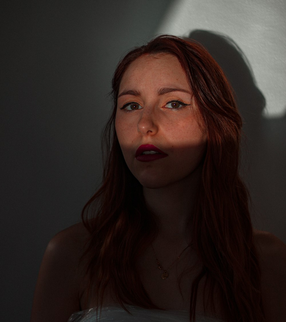 woman in red lipstick and silver necklace