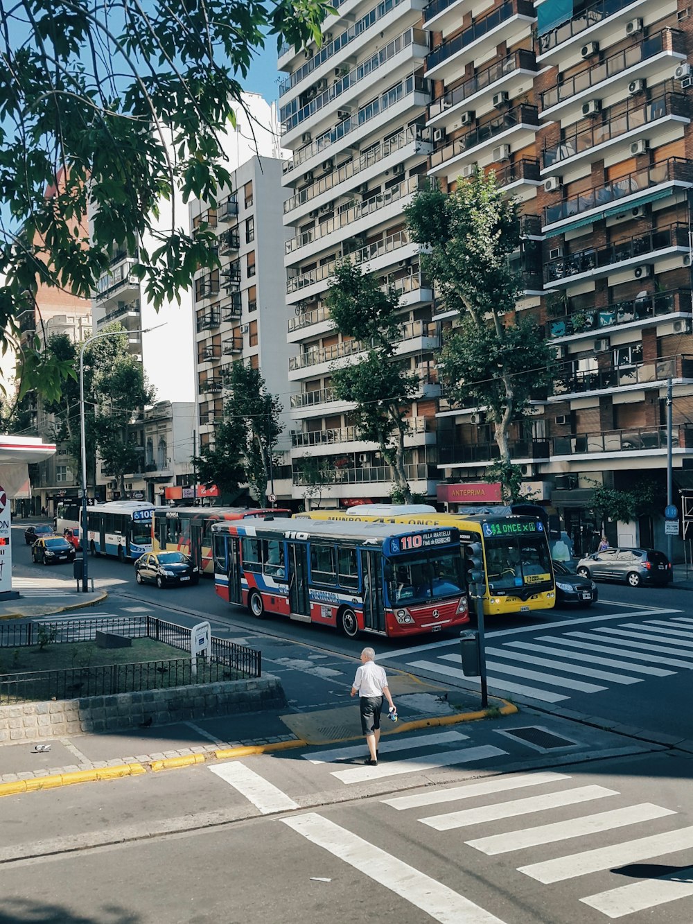 red and white bus on road near building during daytime