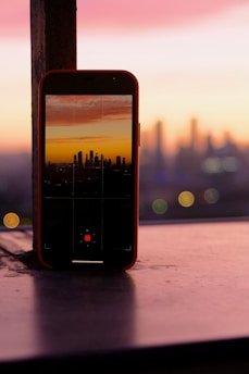 black iphone 4 on brown wooden table