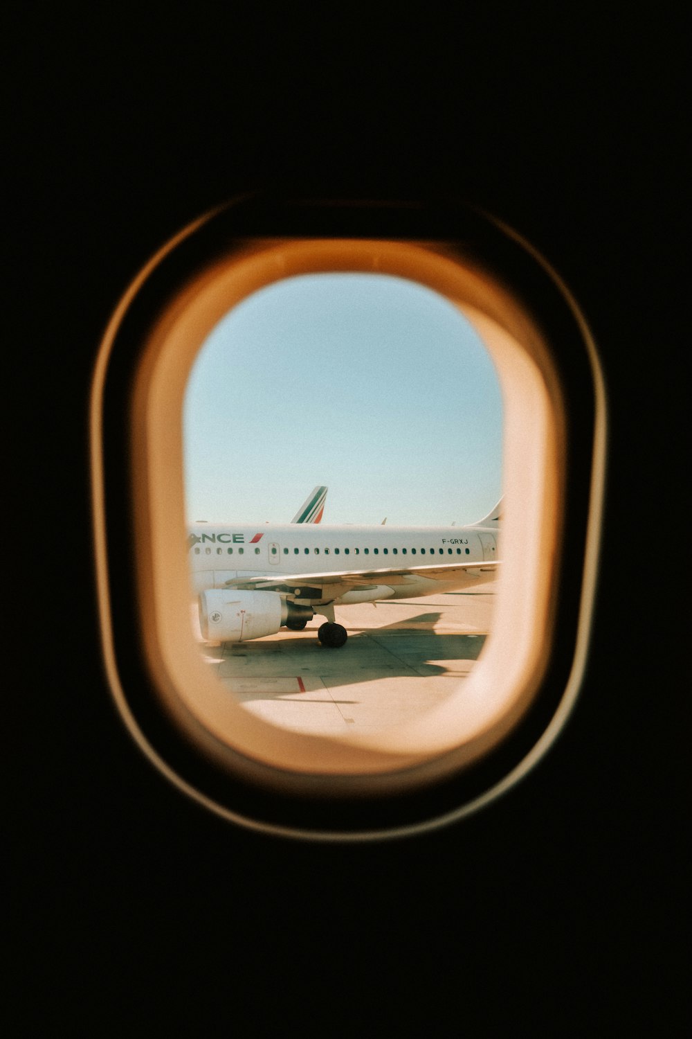 airplane window view of airplane wing during daytime