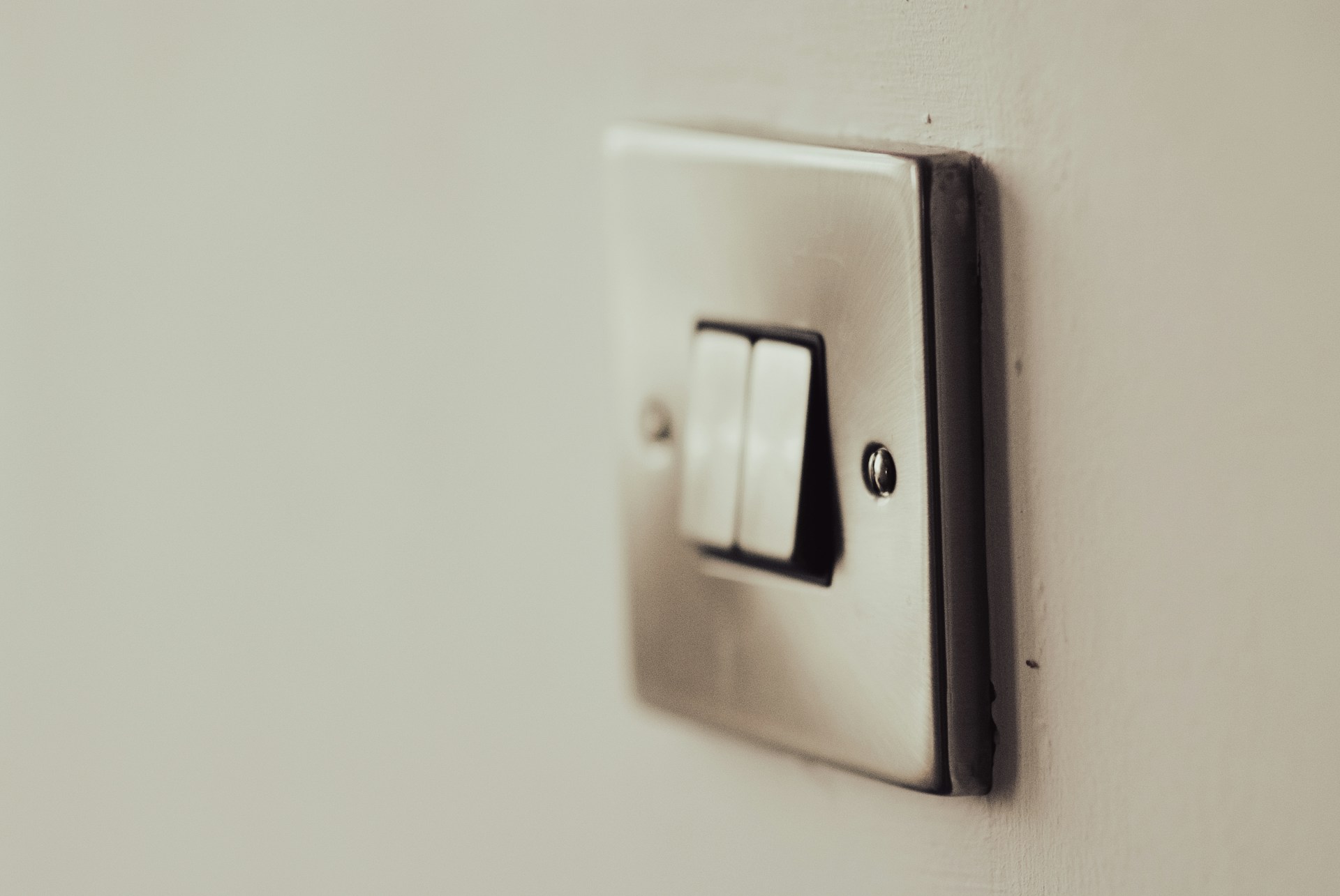 white light switch on white painted wall
