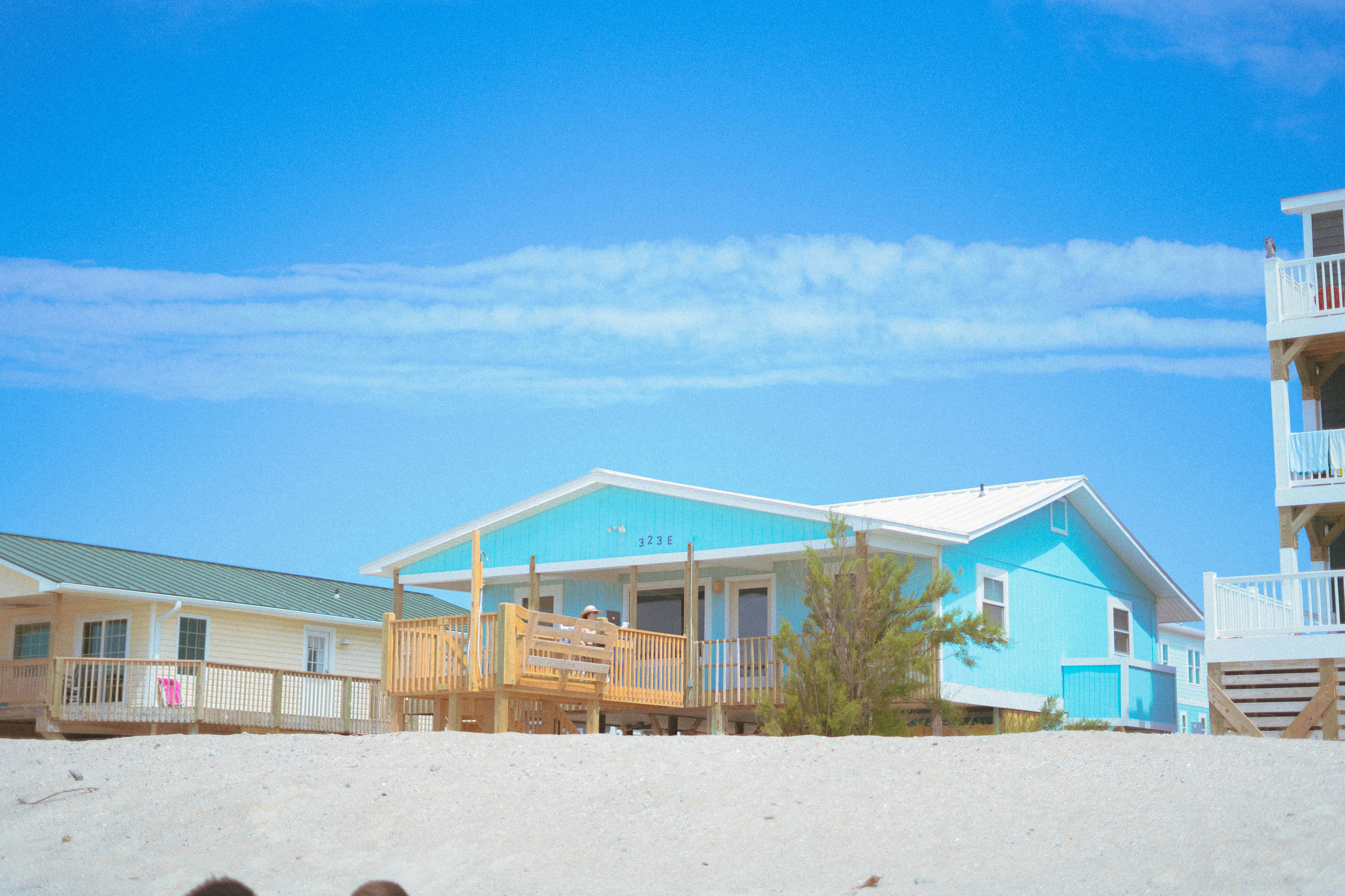 white and brown concrete house under blue sky during daytime