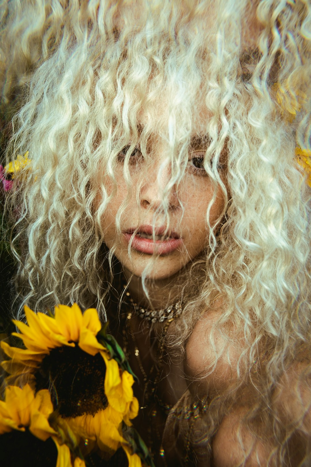 woman in silver and gold necklace