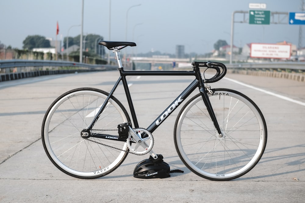 blue and black road bike near body of water during daytime