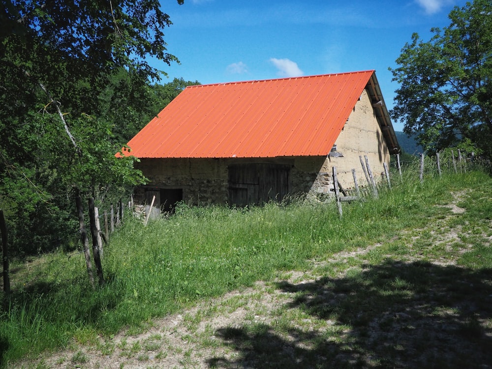 brown wooden house near green trees under blue sky during daytime