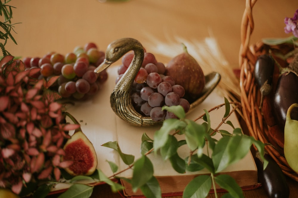 red round fruit on black and white ceramic bowl