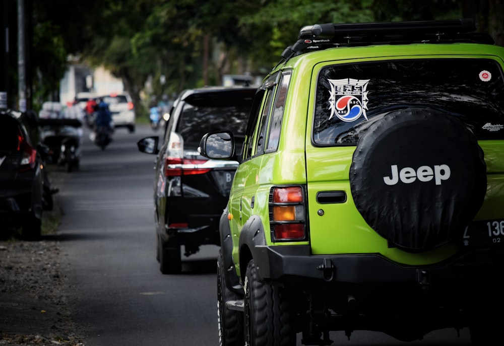 green and black jeep wrangler on road during daytime