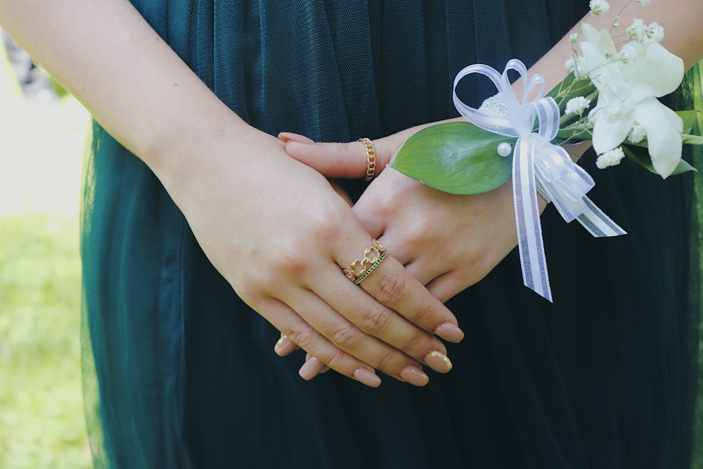 woman in gold ring and gold bracelet