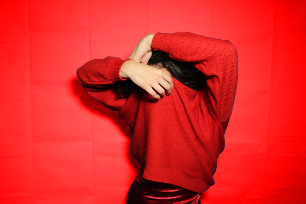 woman in red hijab covering her face