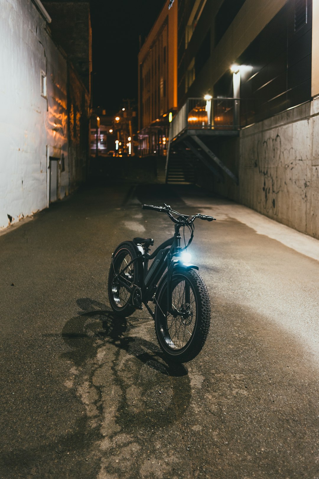 black motorcycle parked beside the road during night time