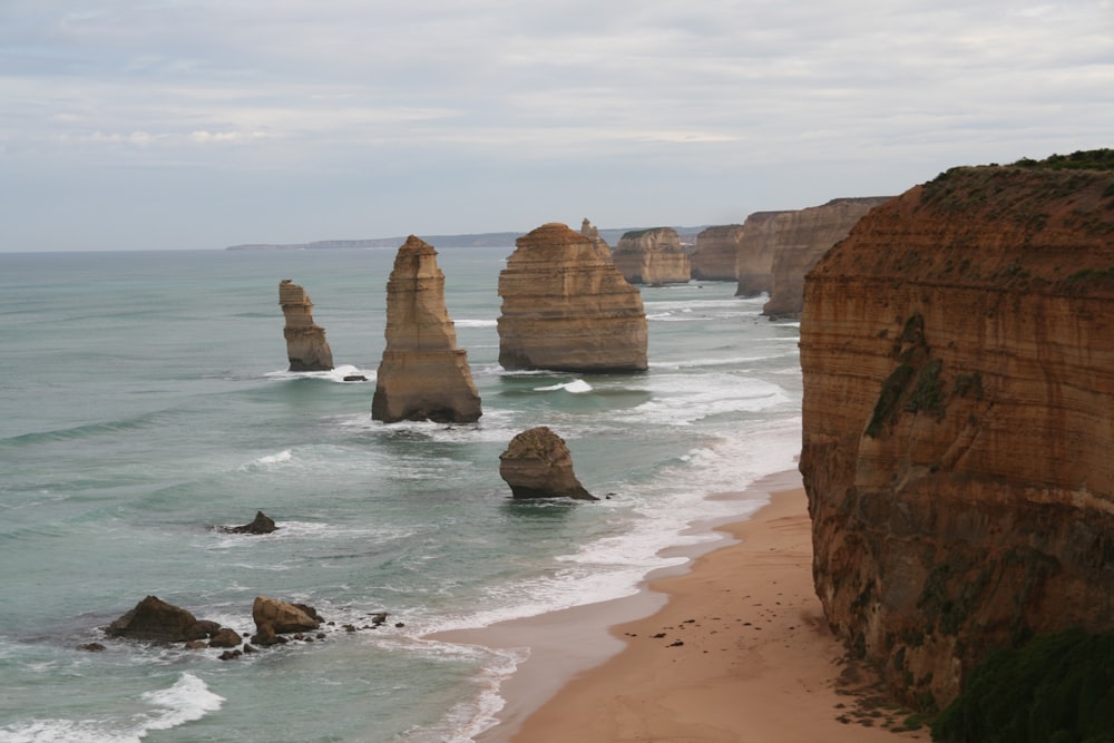 brown rock formation on sea shore during daytime