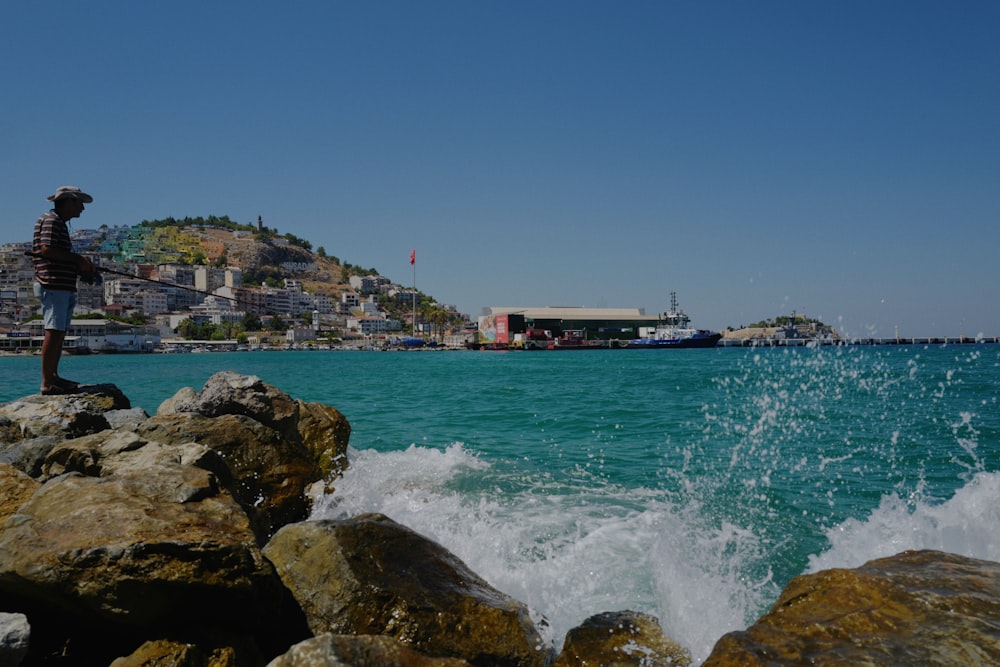 body of water near rocks under blue sky during daytime