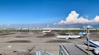 white airplane on gray concrete road during daytime