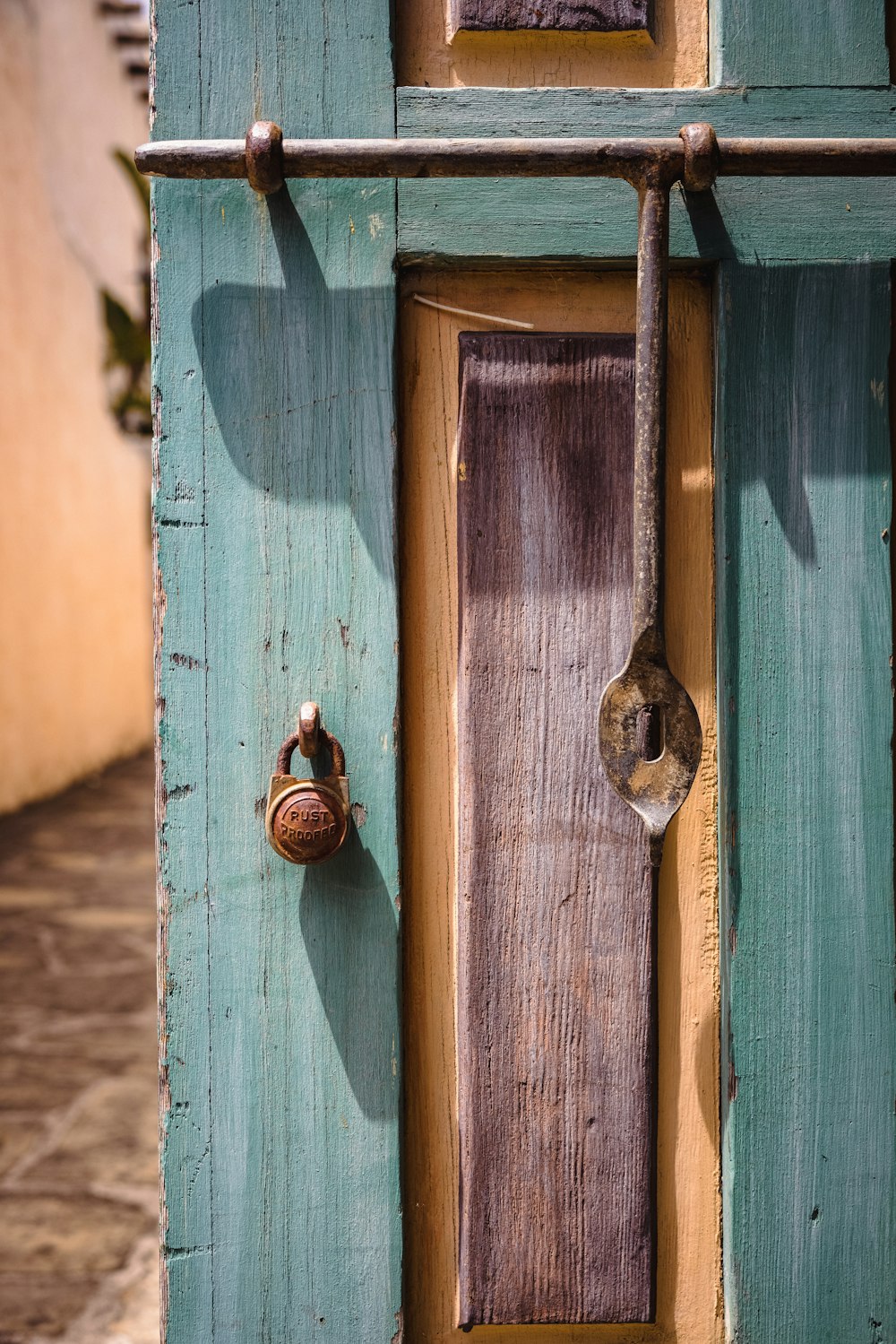 brown wooden door with padlock