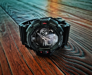 A stylish Casio watch displayed on a wooden surface.