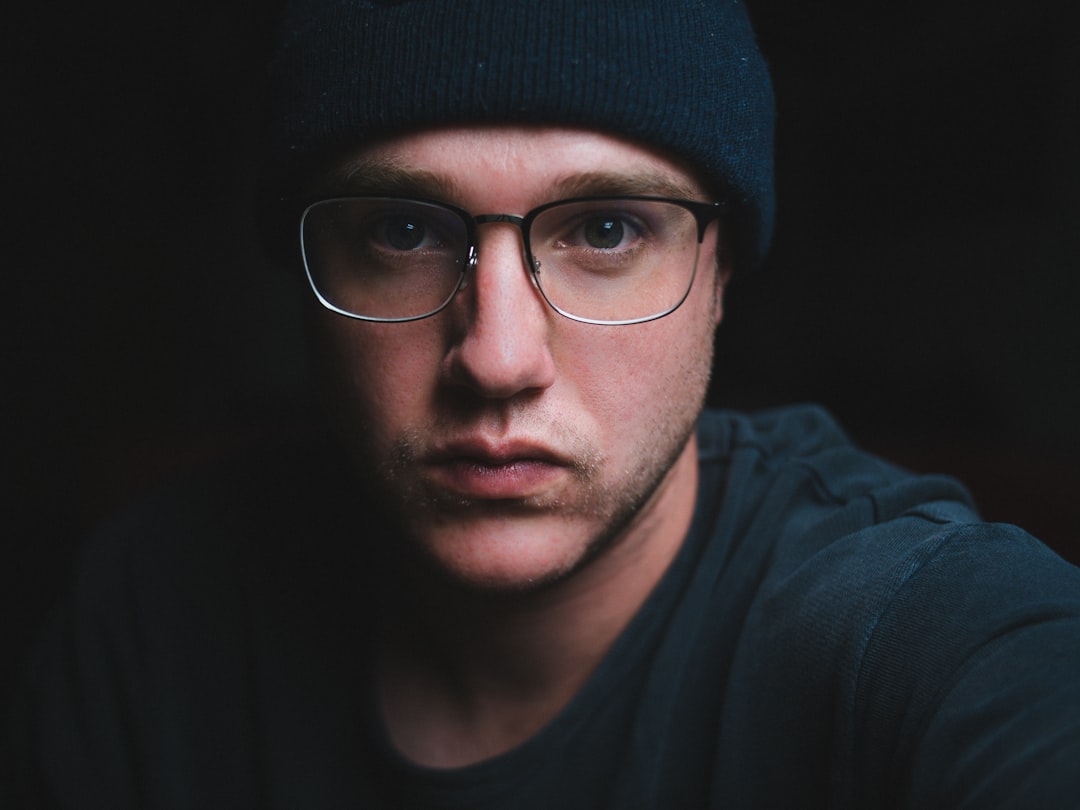 man in black knit cap and black framed eyeglasses