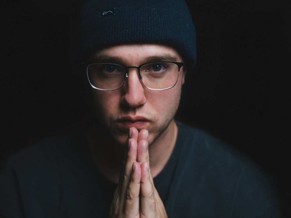 man in black knit cap and black framed eyeglasses