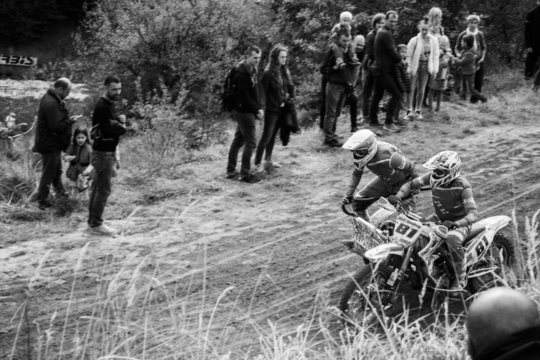 grayscale photo of people riding motorcycle