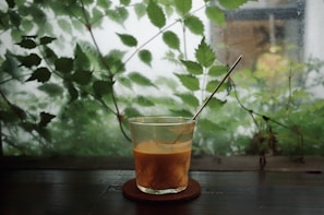 clear drinking glass with brown liquid inside