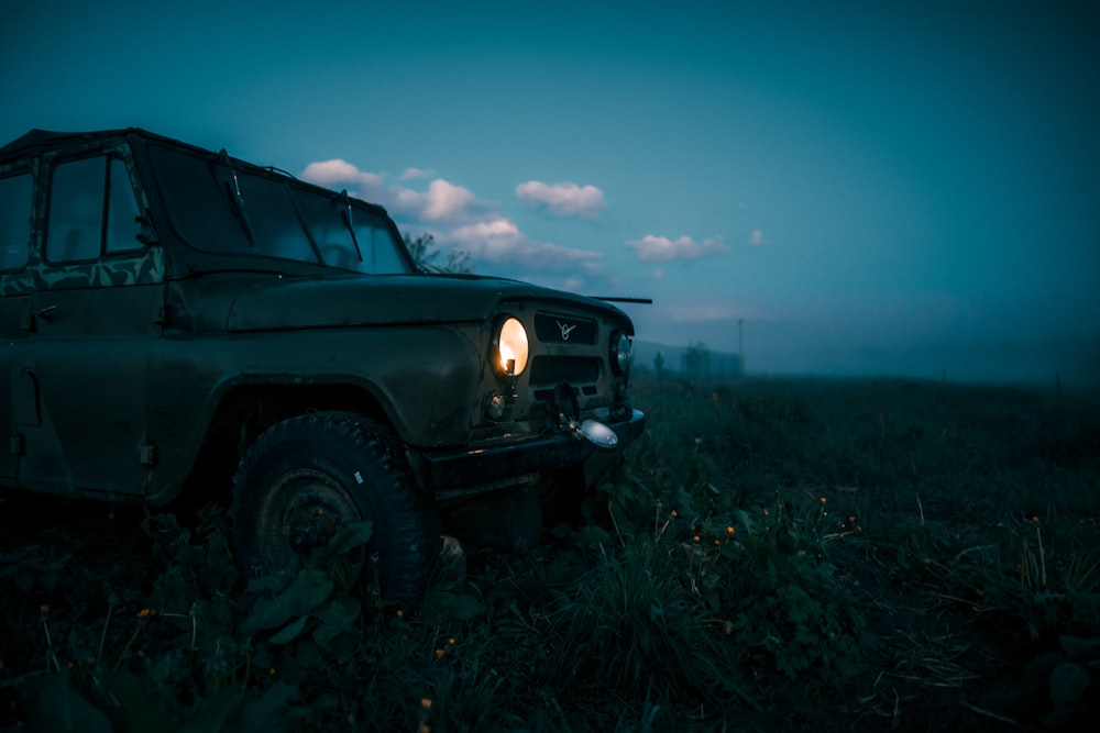 black suv on green grass field under blue sky during daytime