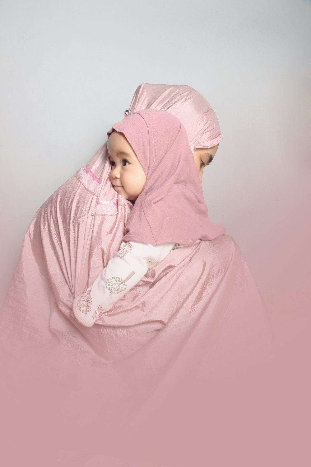 woman in pink hijab and abaya
