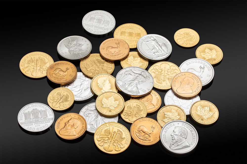 gold round coins on black surface