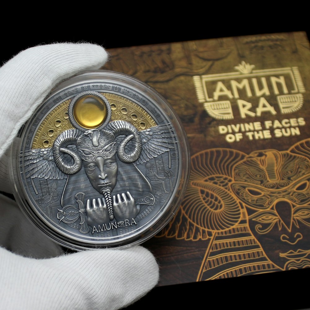 silver round coin on brown wooden table