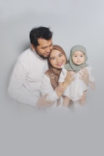 man in white dress shirt carrying girl in white dress