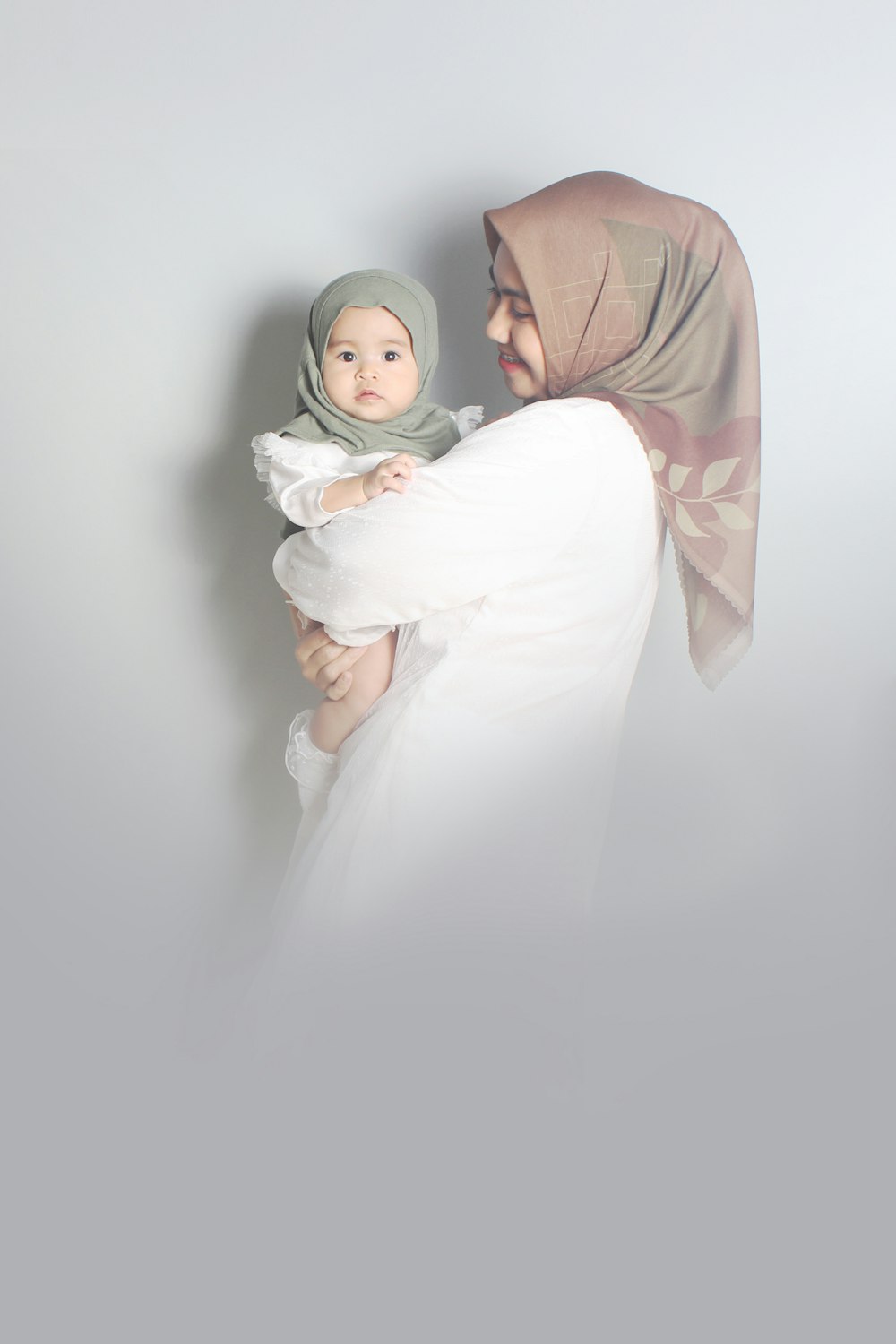 woman in white hijab and white abaya