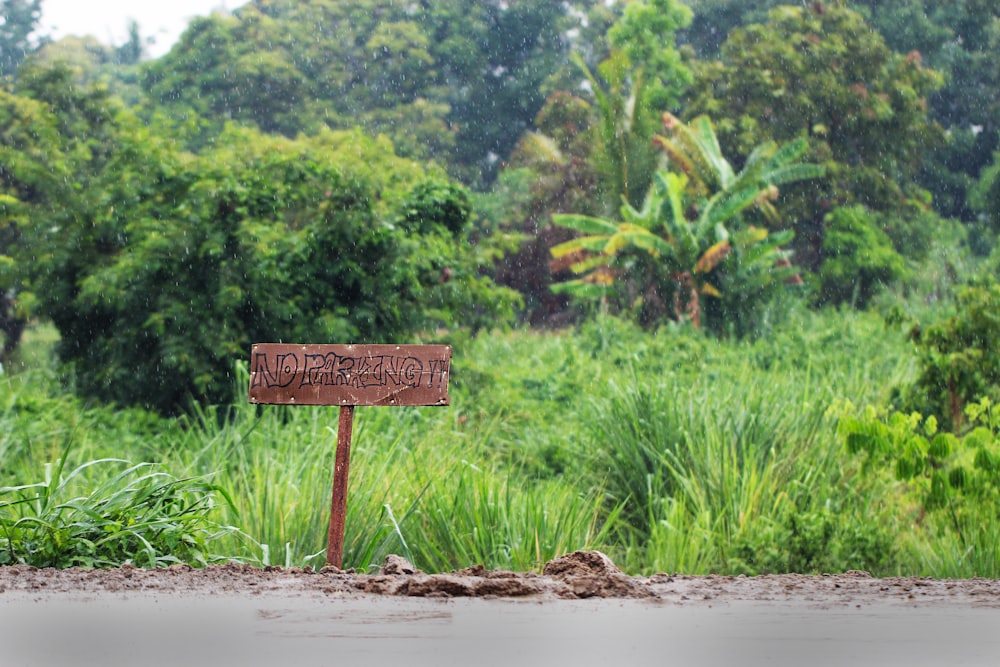 brown wooden signage on brown sand