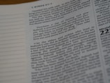 A close-up of a page from a book, featuring text printed in black on a white background. The text is arranged in paragraphs with numbered sections and some quotations. The left margin is visible, with dotted lines on the page.
