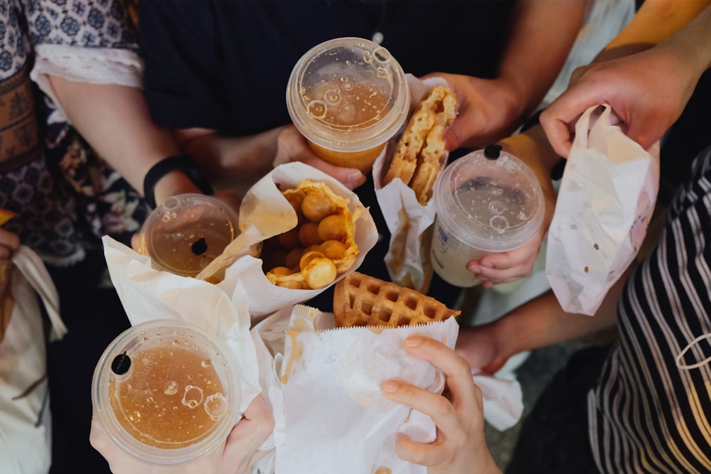 person holding burger and fries