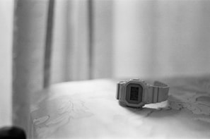 A softly lit scene showing a user browsing watches on a tablet.