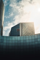 gray concrete building under white clouds during daytime