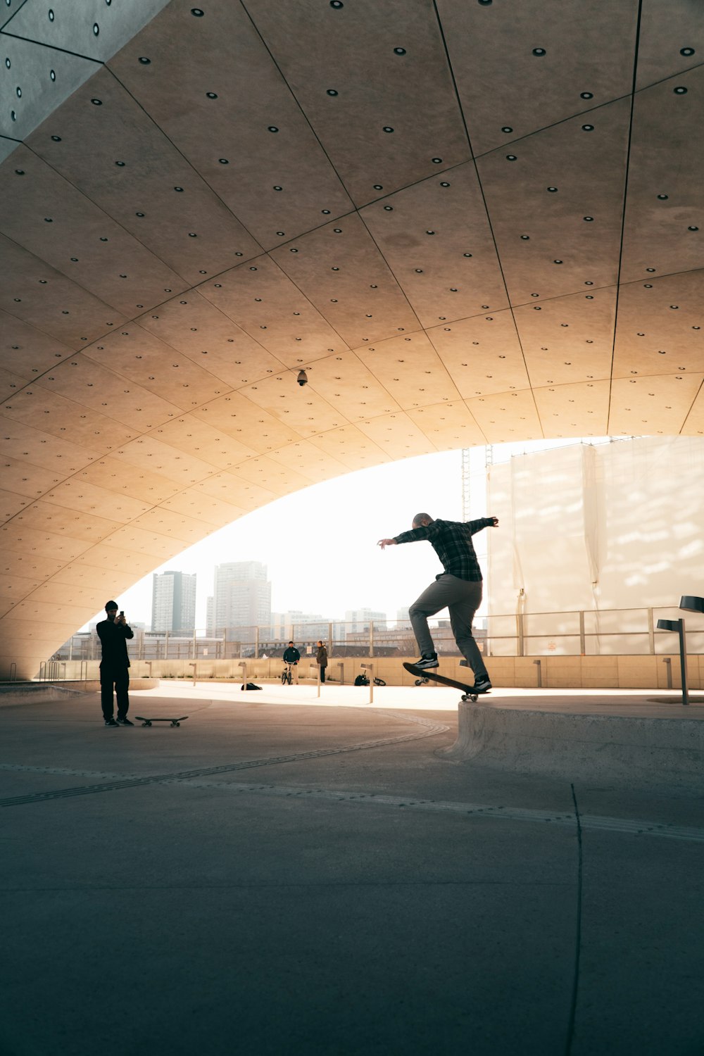 man in black jacket and black pants jumping on white concrete floor