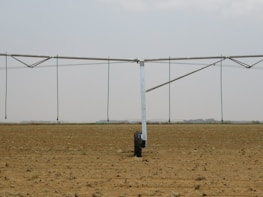 A contractor inspecting a large agricultural irrigation system using Ridhi Sidhi Industries fittings.