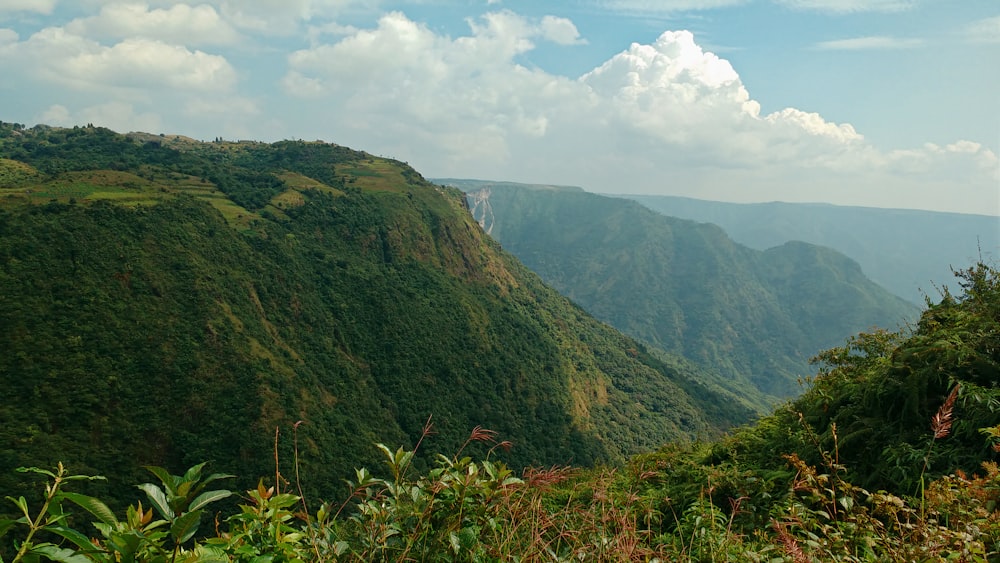 green mountain under white clouds during daytime