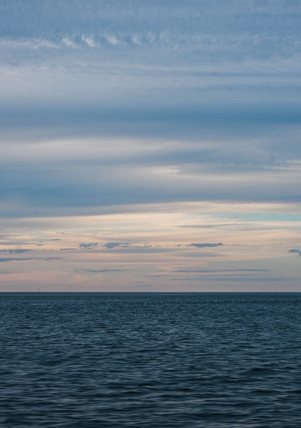 body of water under cloudy sky during daytime