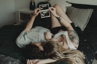 woman in blue shirt lying on bed