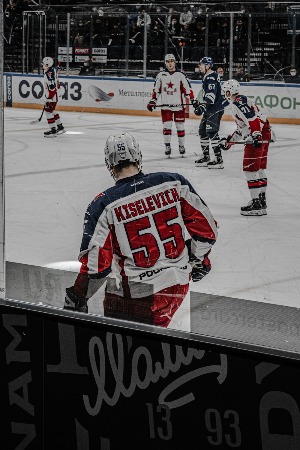 man in red and white ice hockey jersey playing hockey