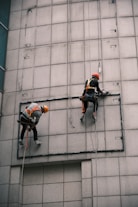 man in orange helmet riding bicycle during daytime