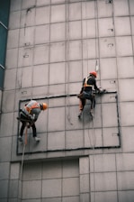 man in orange helmet riding bicycle during daytime