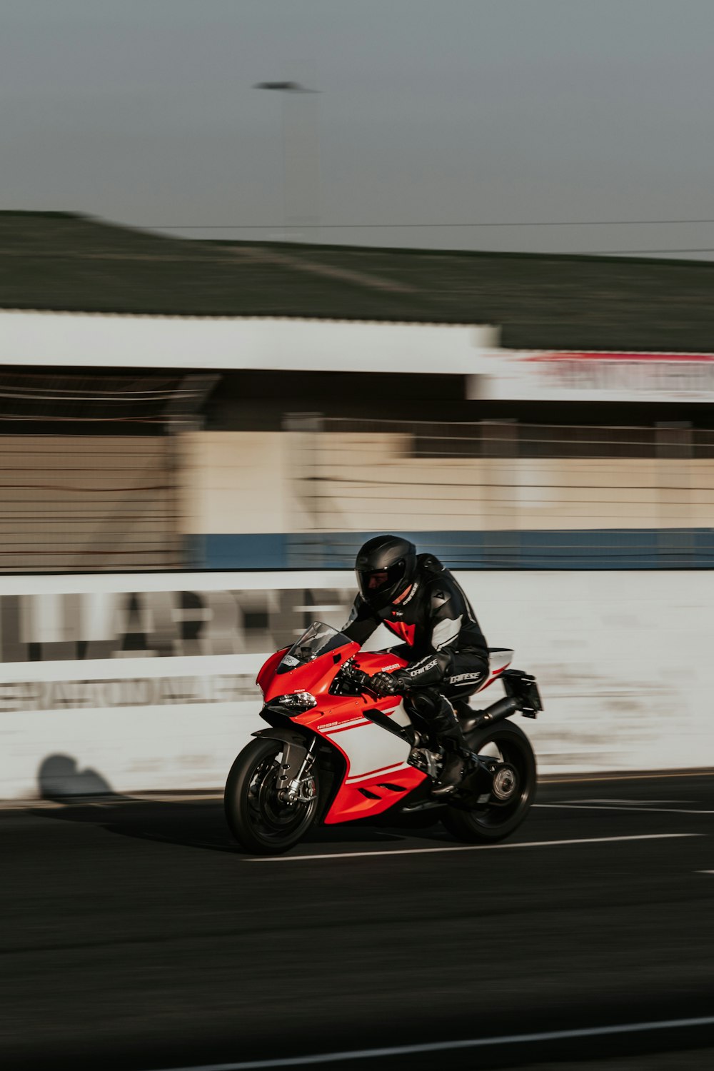 man in black helmet riding red sports bike