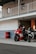 man in black and red motorcycle helmet riding red and white sports bike