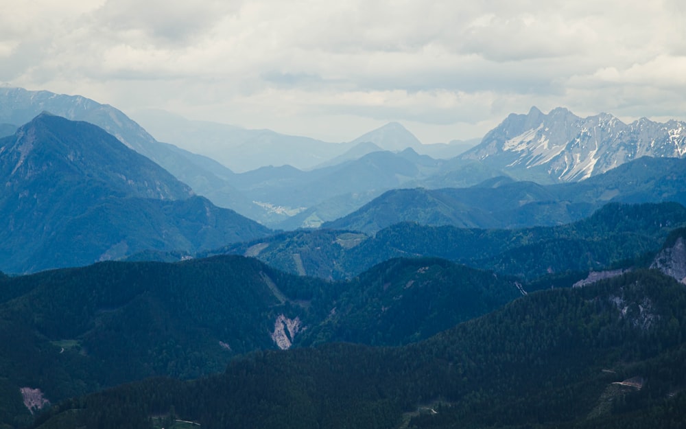 green mountains under white clouds during daytime