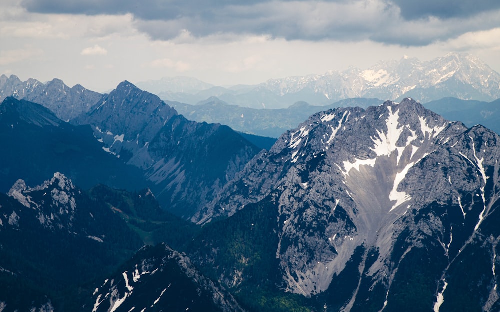 snow covered mountain under cloudy sky during daytime