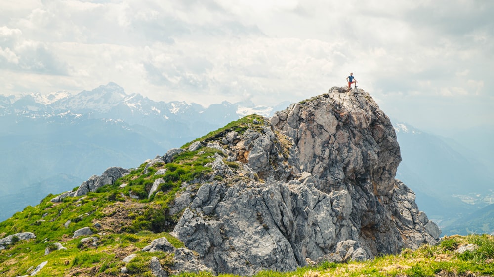 person standing on rock formation during daytime