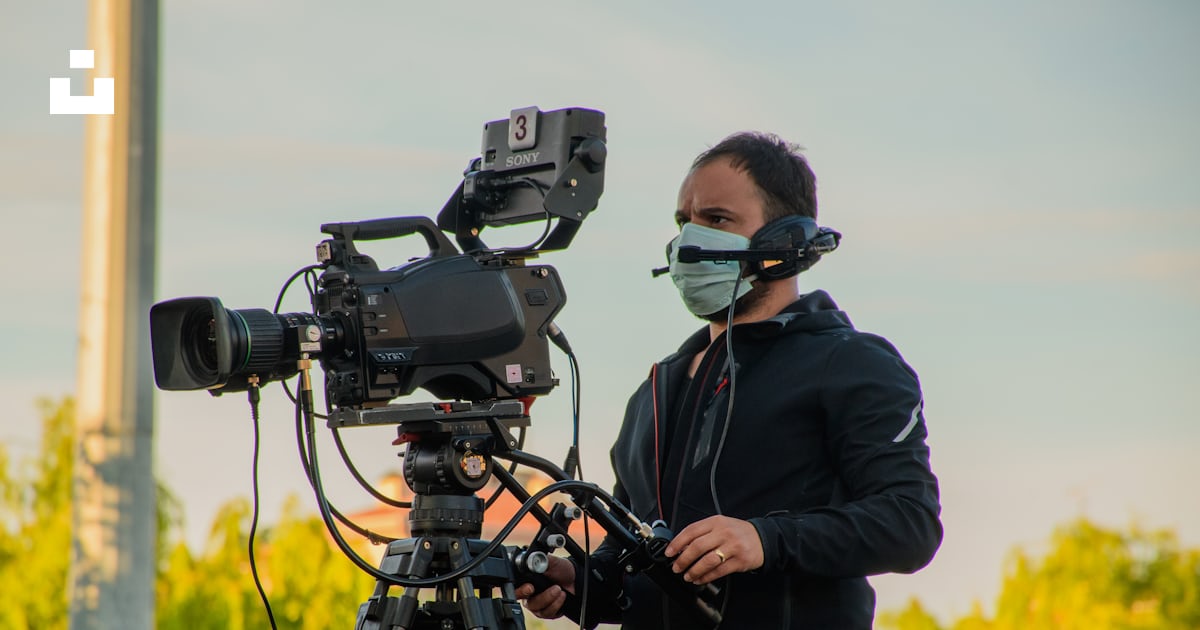 Man in black jacket using black dslr camera photo – Free Camera ...