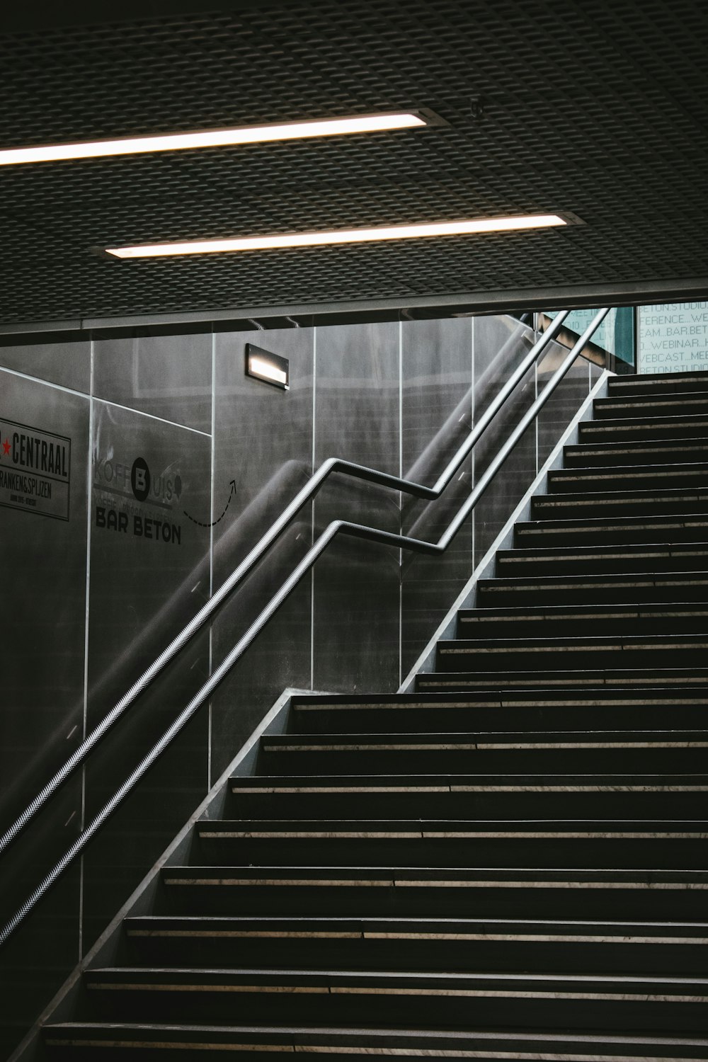 black and white staircase with stainless steel railings